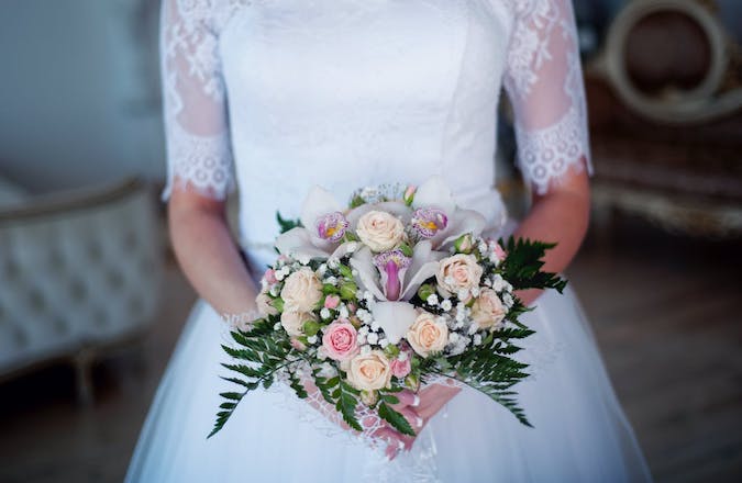 women in wedding dress with bouquet