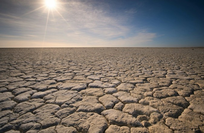Sun shining over an expanse of dry land
