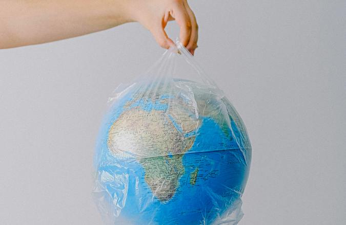 globe in a single use plastic bag