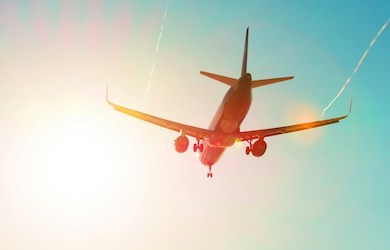 Plane flying into sun