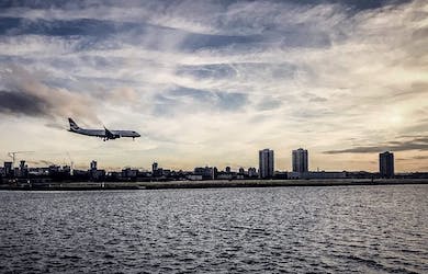 Plane landing with city background