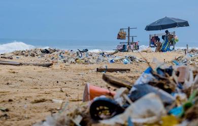 Image of a beach covered in plastic waste
