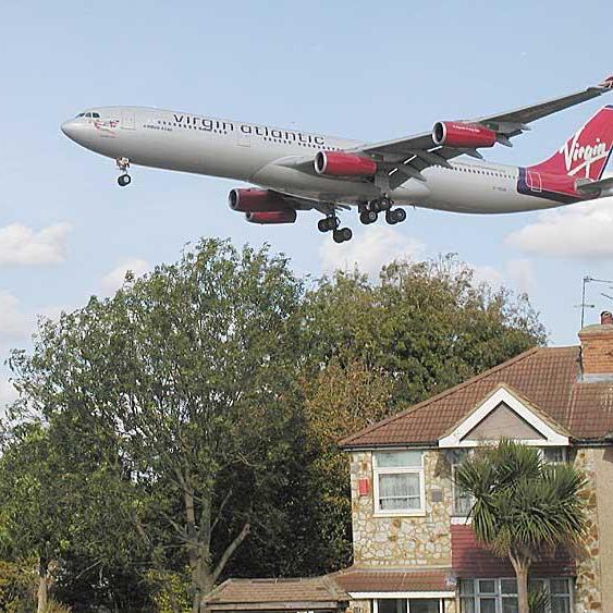 Plane flying over houses